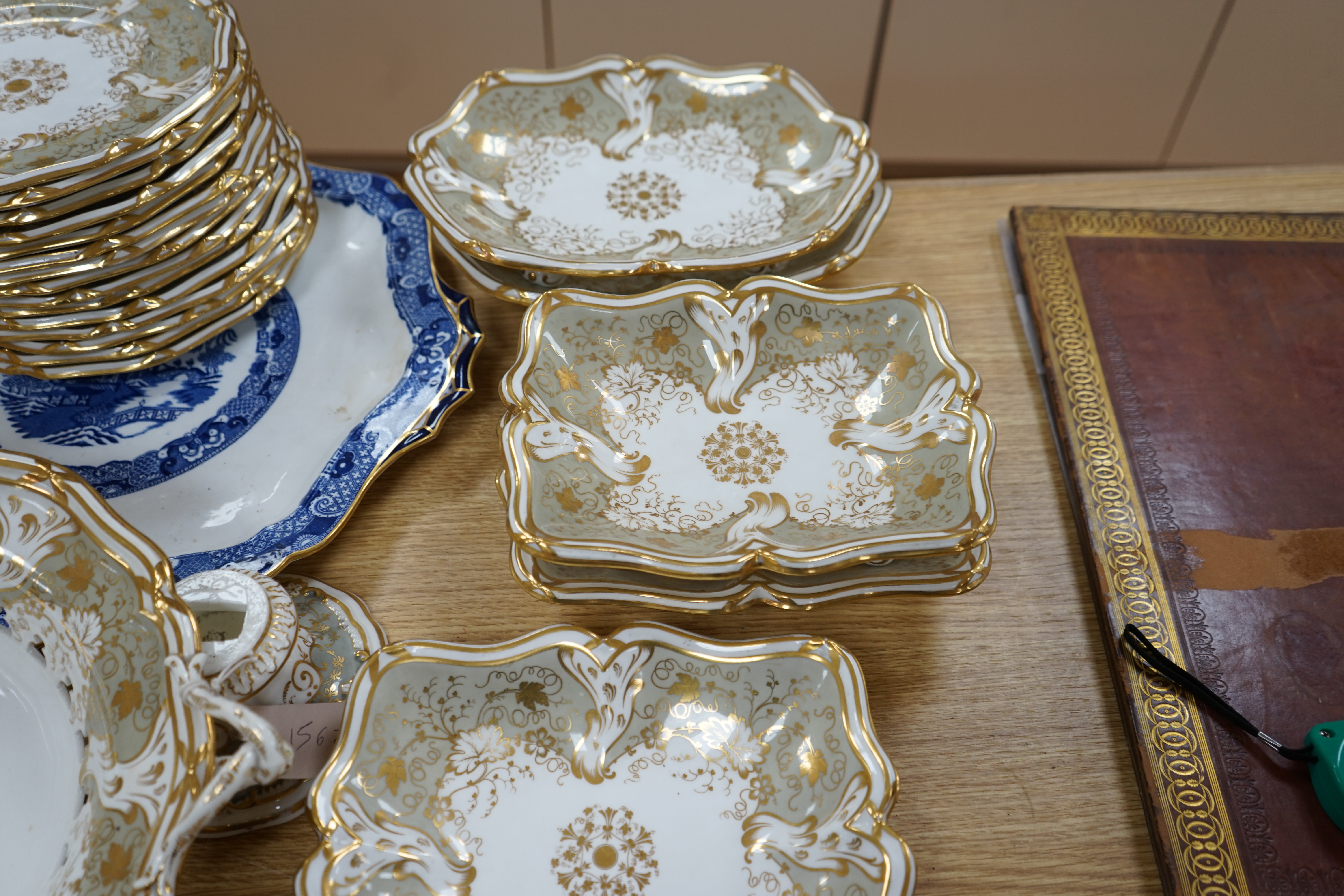 A Davenport part grey and gilt dessert service, together with a blue and white circular serving dish, dish 43cm wide. Condition - comport base broken